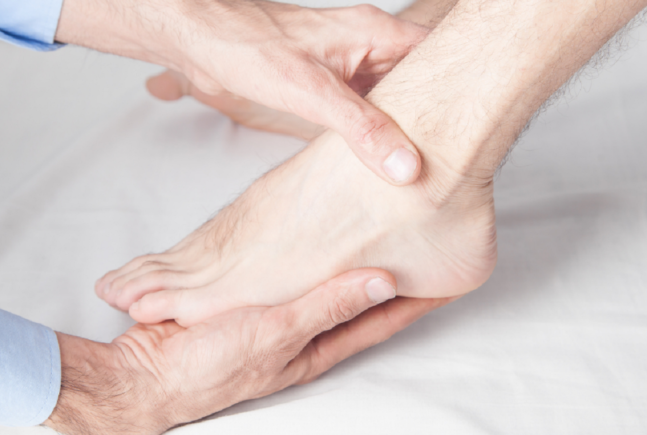 Doctor holding patient's foot